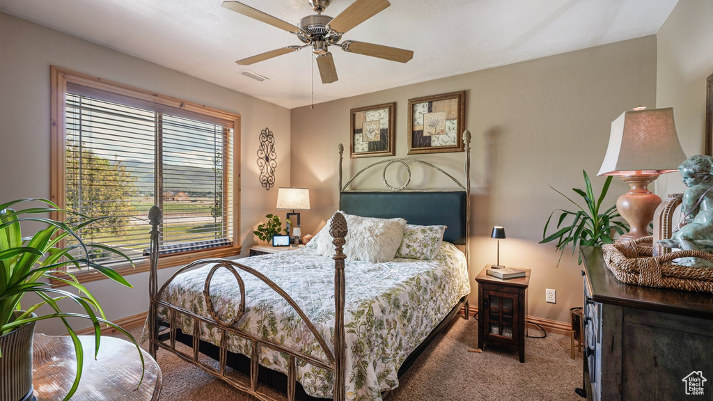 Bedroom featuring carpet flooring, baseboards, and ceiling fan
