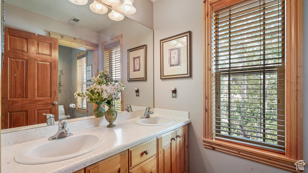 Bathroom with toilet and double vanity