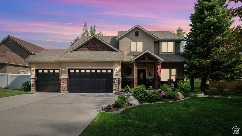 View of front of home featuring stucco siding, an attached garage, concrete driveway, and a shingled roof