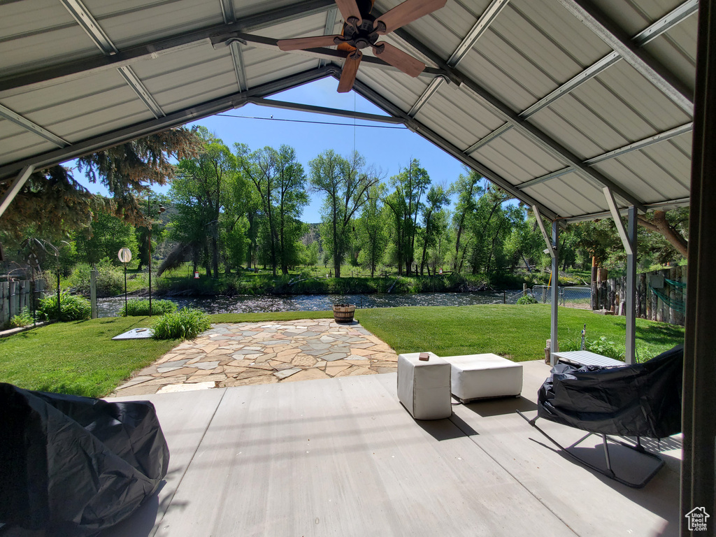 View of patio / terrace with a ceiling fan and a water view