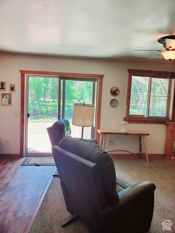 Living room featuring a ceiling fan and baseboards