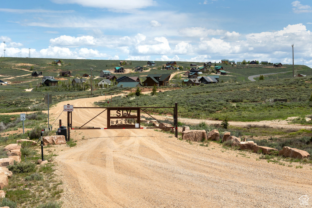 View of street with a gate, a view of rural / pastoral area, and a gated entry
