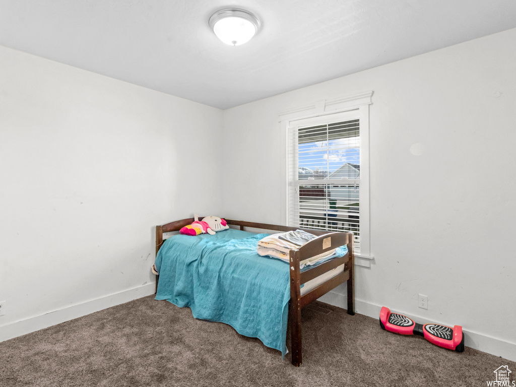 Bedroom with carpet floors and baseboards