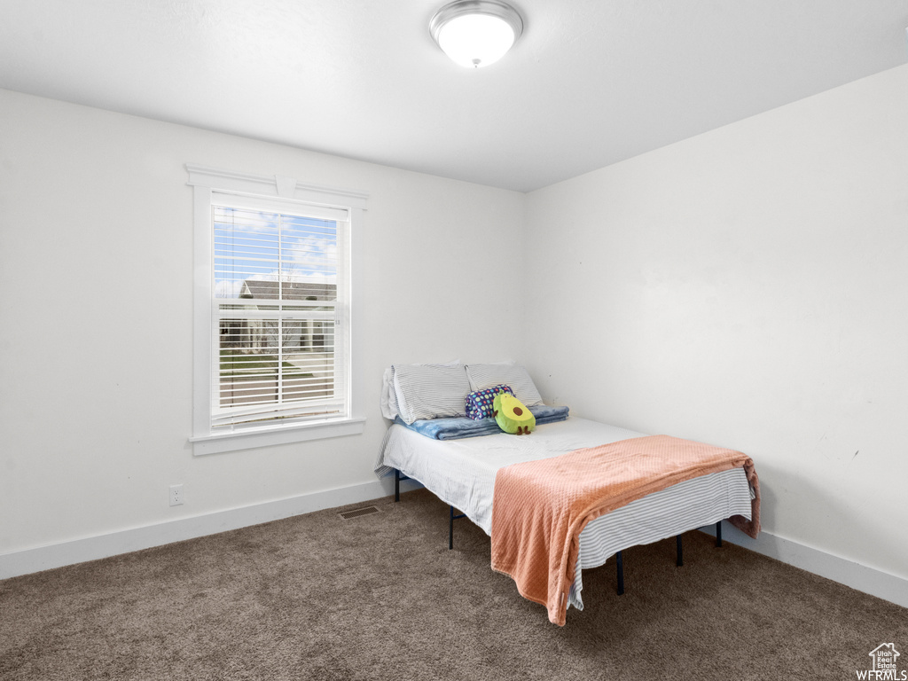 Carpeted bedroom with baseboards