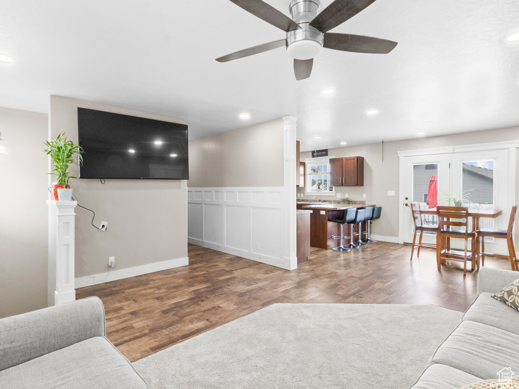 Living area with wood finished floors, a ceiling fan, and recessed lighting