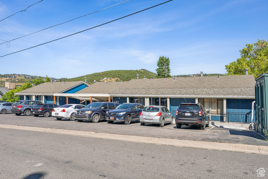 View of front of house with uncovered parking and a mountain view