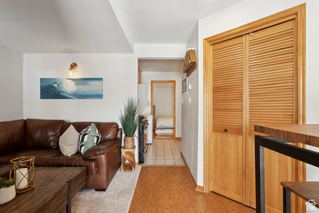 Living area featuring light wood-style flooring and baseboards