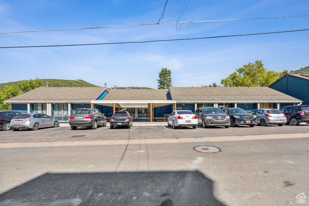 View of building exterior with uncovered parking