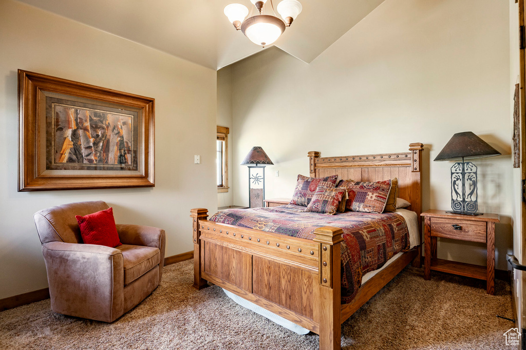 Bedroom featuring carpet floors, baseboards, and lofted ceiling
