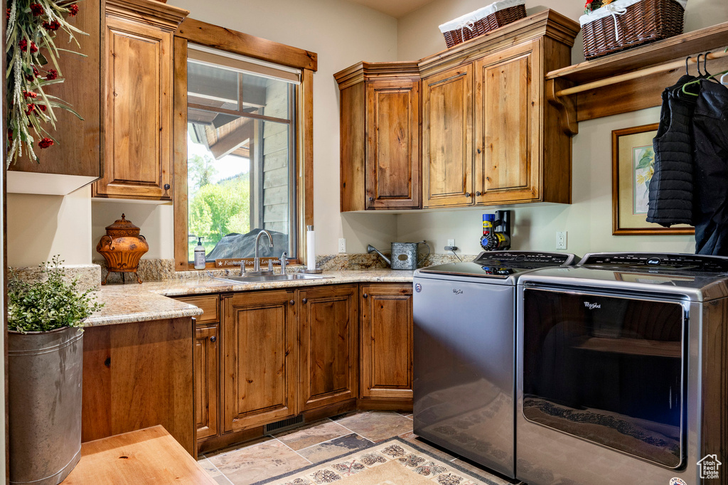 Laundry room featuring cabinet space and washing machine and dryer