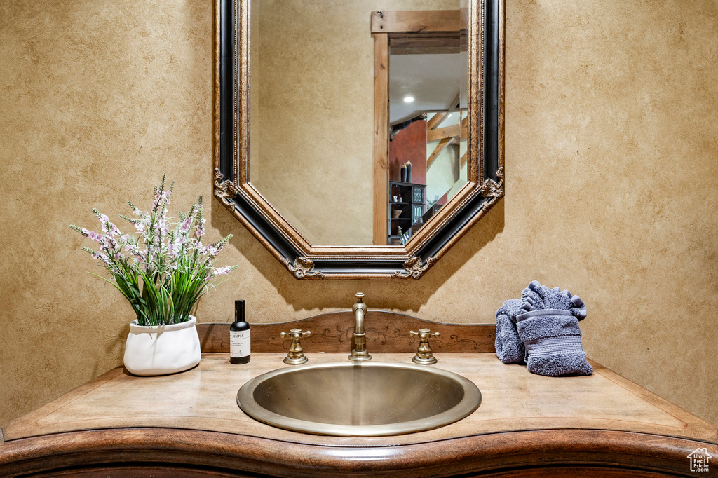 Bathroom with vanity and a textured wall