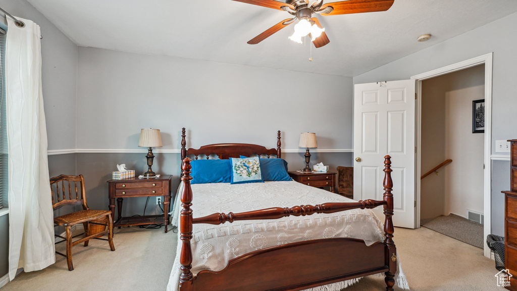 Carpeted bedroom with a ceiling fan