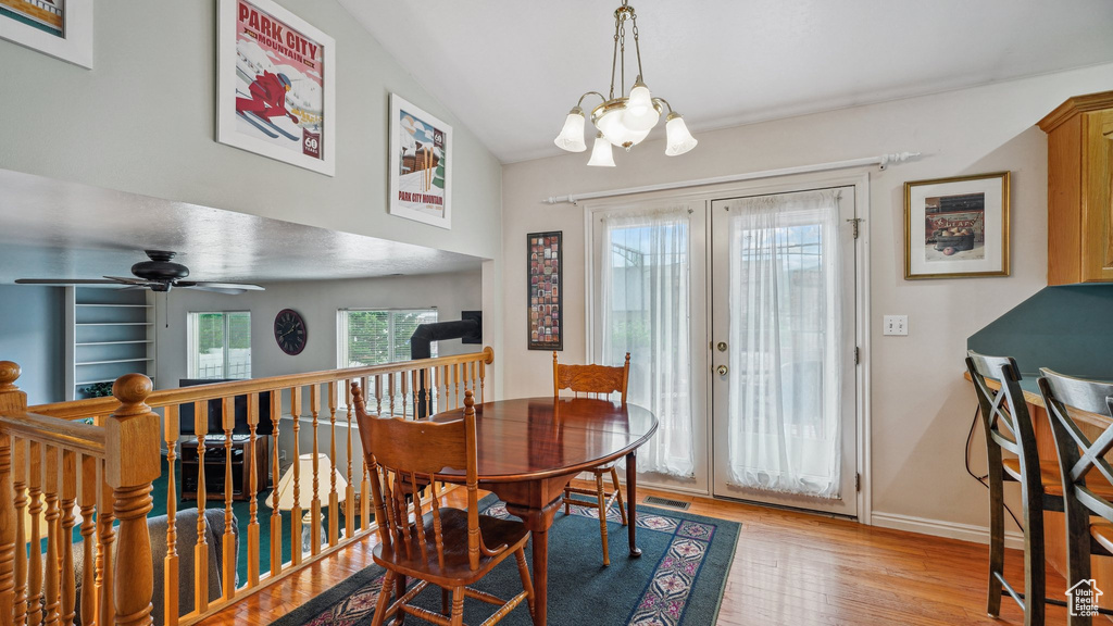 Dining space featuring a chandelier, wood finished floors, french doors, baseboards, and ceiling fan