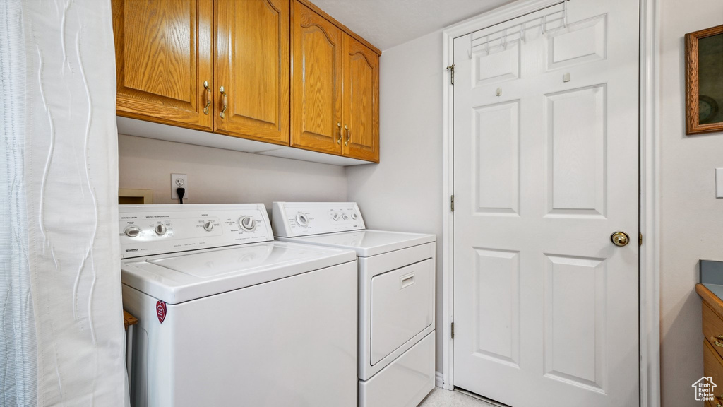 Laundry area with washing machine and clothes dryer and cabinet space