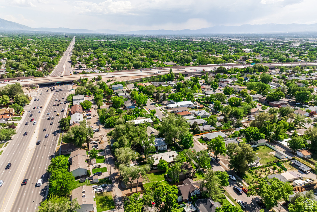 Aerial view of residential area with a highway and a mountainous background