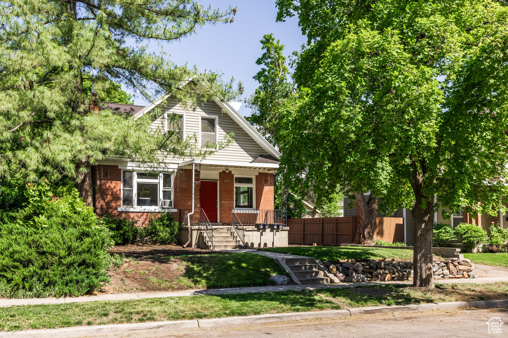 Bungalow-style home featuring brick siding and covered porch