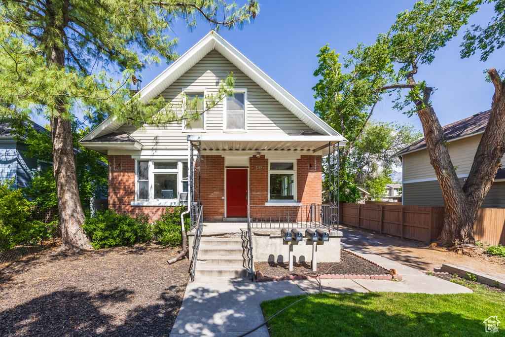 Bungalow with brick siding and a porch