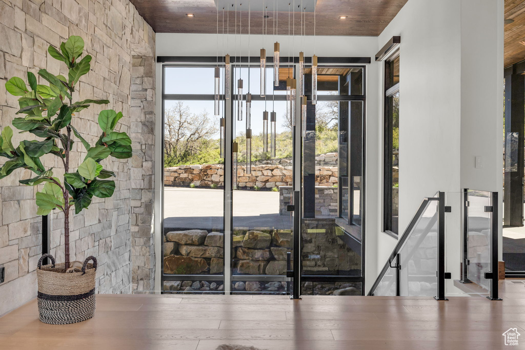 Doorway to outside with wood finished floors and wooden ceiling