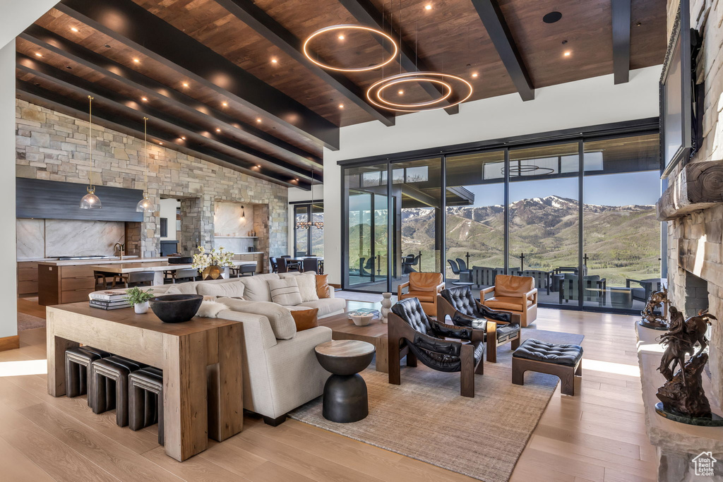 Living area with wooden ceiling, light wood-style floors, and a chandelier