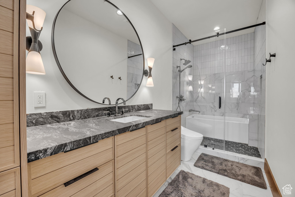 Bathroom featuring vanity, a stall shower, toilet, marble look tile flooring, and recessed lighting