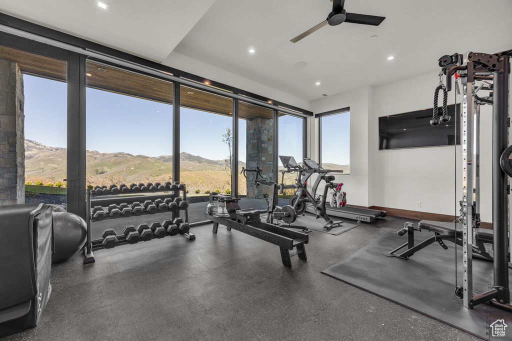 Workout area with a ceiling fan and recessed lighting