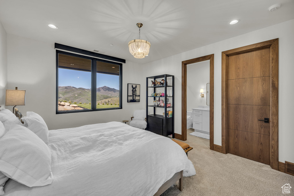 Bedroom featuring light carpet, a chandelier, connected bathroom, baseboards, and recessed lighting
