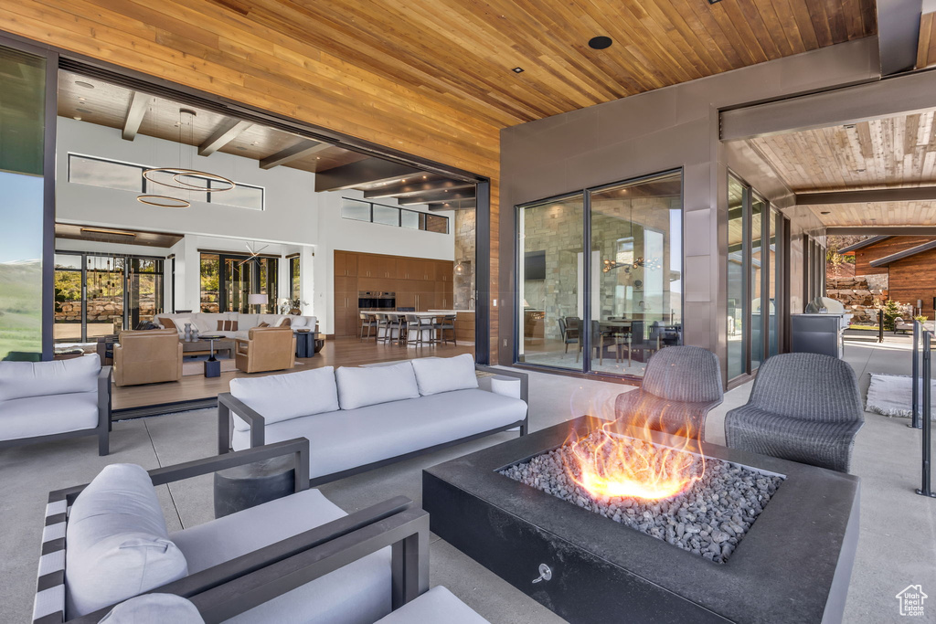 View of patio featuring an outdoor living space with a fire pit
