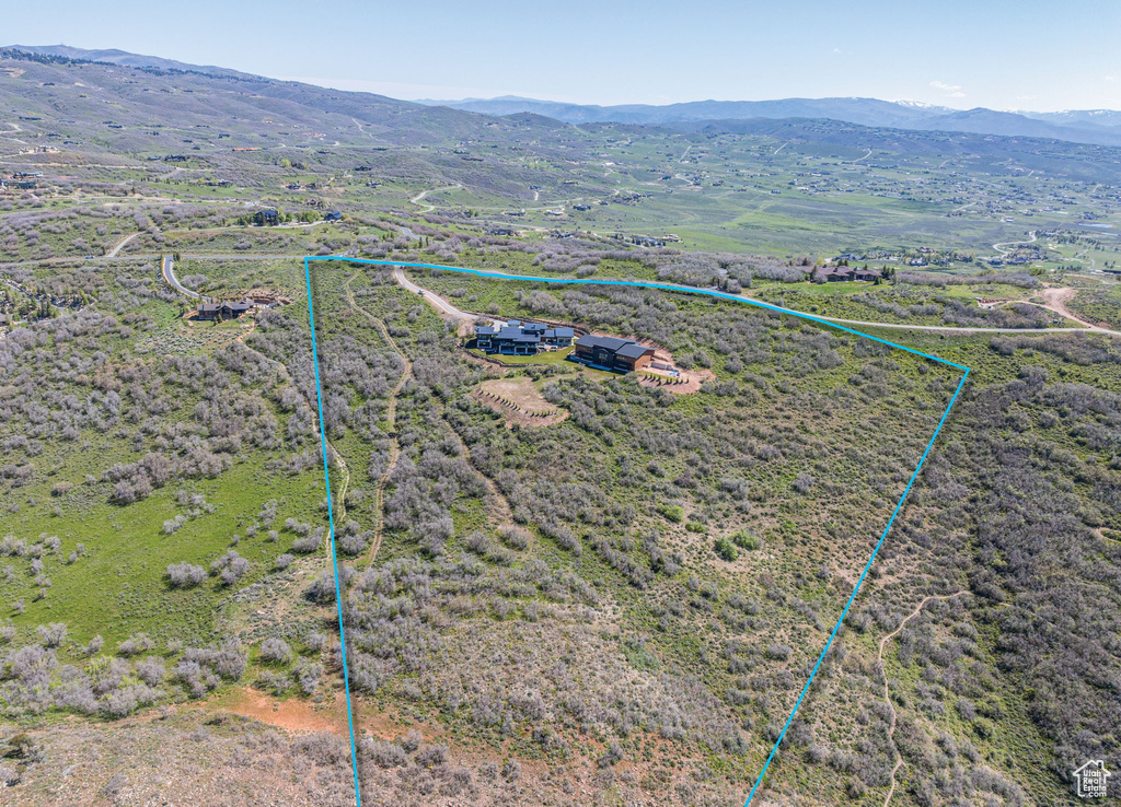 Overview of rural landscape with property boundaries highlighted and mountains