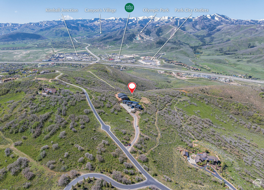 Aerial overview of property's location with a mountain backdrop and rural landscape