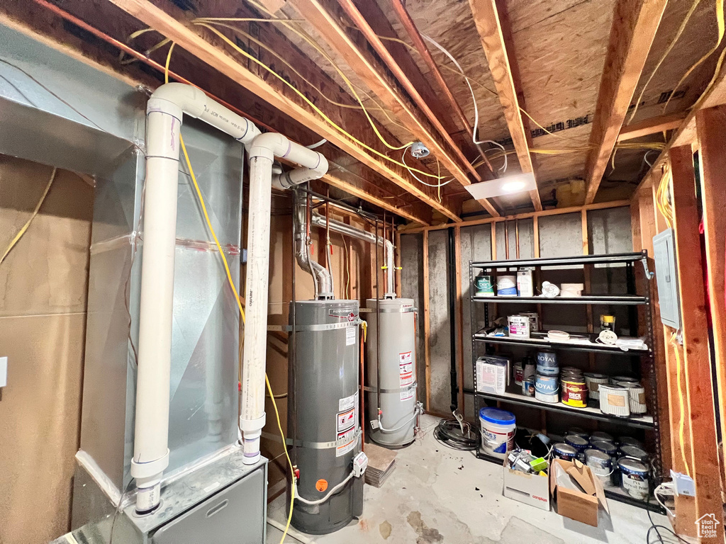 Unfinished basement with water heater and gas water heater