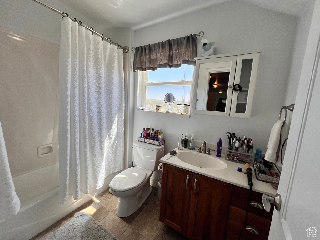 Full bath with vanity, toilet, shower / bathtub combination with curtain, and tile patterned flooring