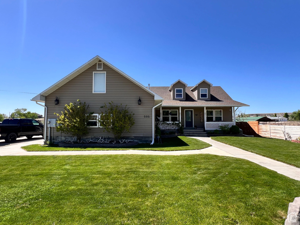 View of front of house with covered porch and a shingled roof