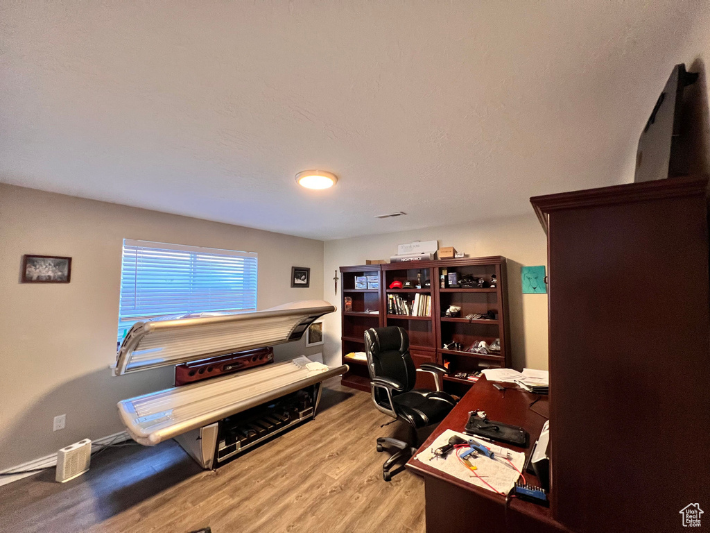 Home office featuring wood finished floors