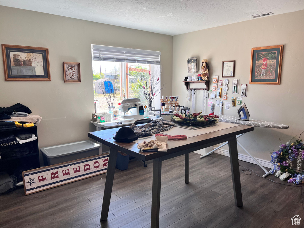 Office area with wood finished floors and a textured ceiling