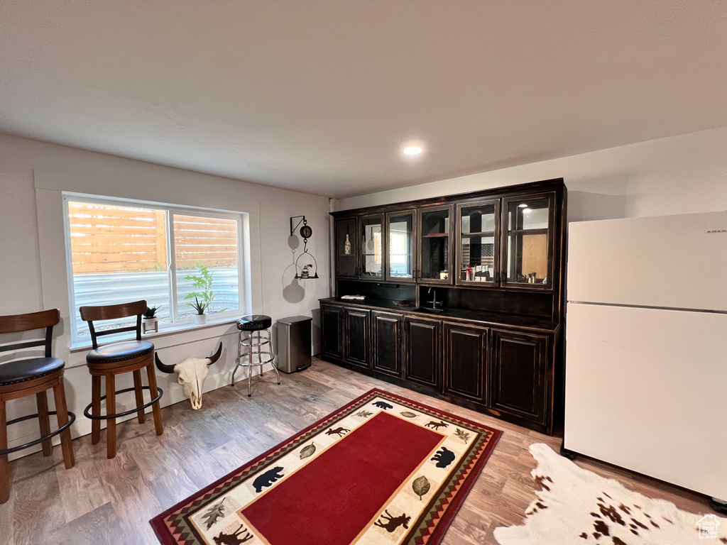Interior space featuring freestanding refrigerator and light wood-style floors