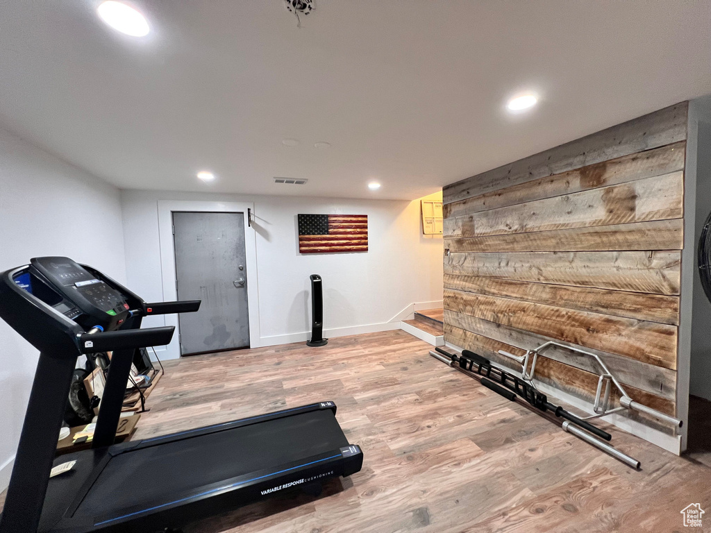 Exercise room featuring wood finished floors, recessed lighting, and baseboards