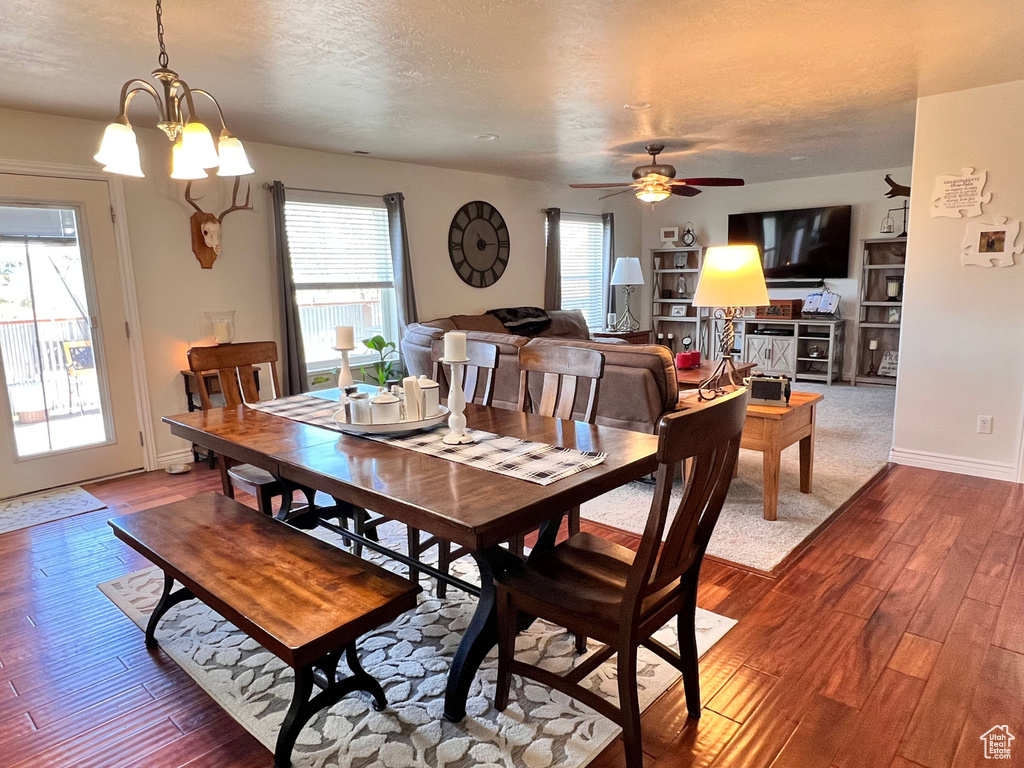 Dining room featuring dark wood-type flooring, plenty of natural light, ceiling fan, and a textured ceiling