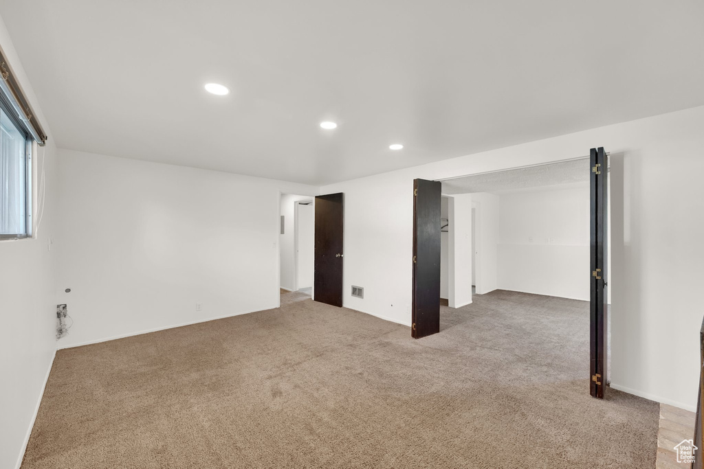 Carpeted spare room with recessed lighting