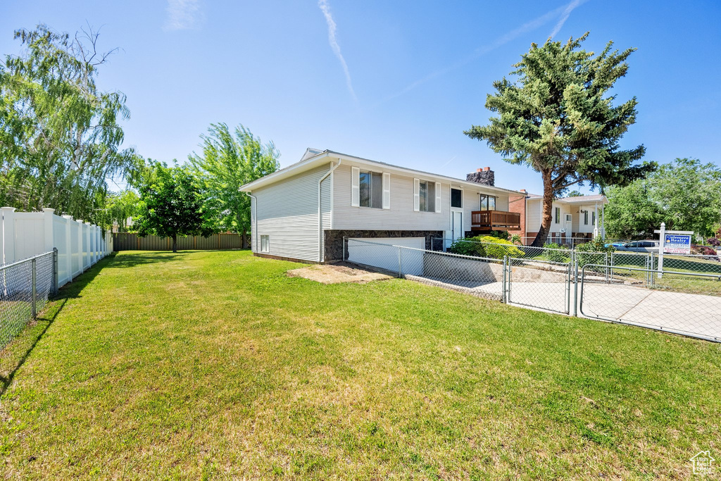 View of yard featuring driveway and an attached garage