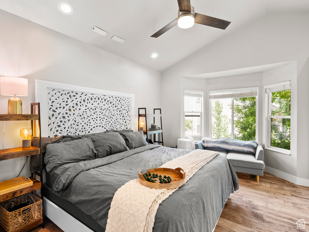 Bedroom with light wood-style floors, recessed lighting, a ceiling fan, baseboards, and high vaulted ceiling