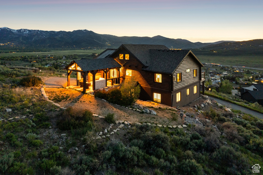 View of front of house featuring a mountain view and a shingled roof