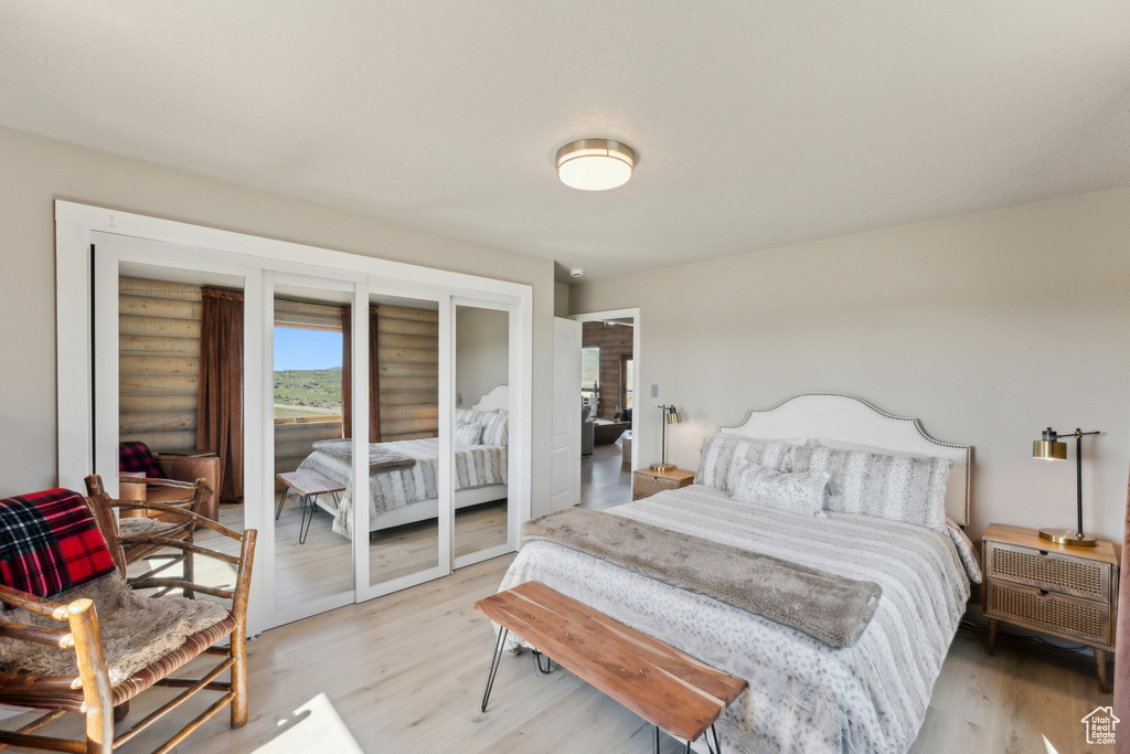 Bedroom featuring light wood finished floors and access to outside