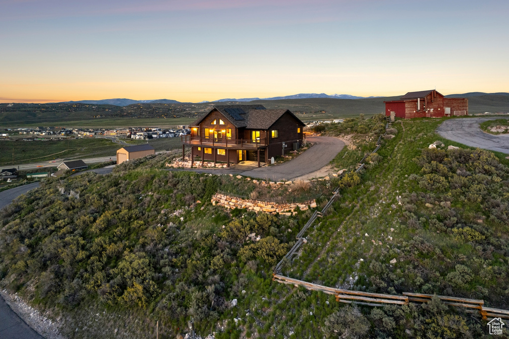 Rear view of house featuring a deck with mountain view and an outbuilding