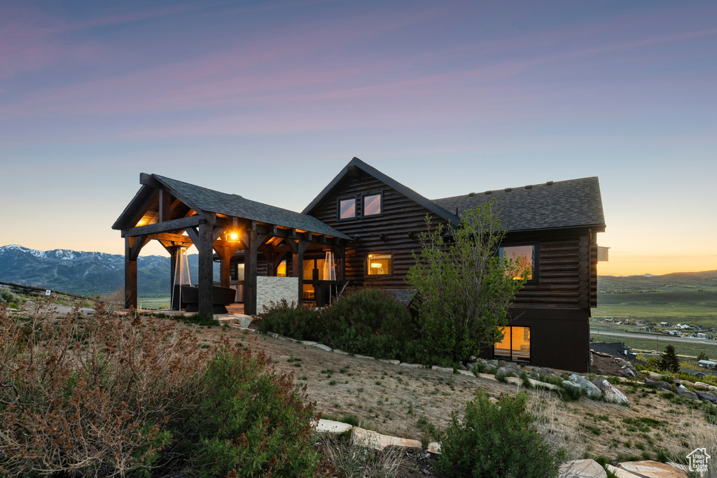 Log-style house featuring log exterior and roof with shingles