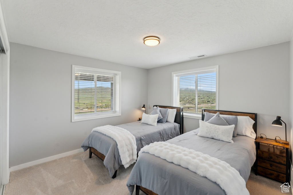 Carpeted bedroom featuring baseboards