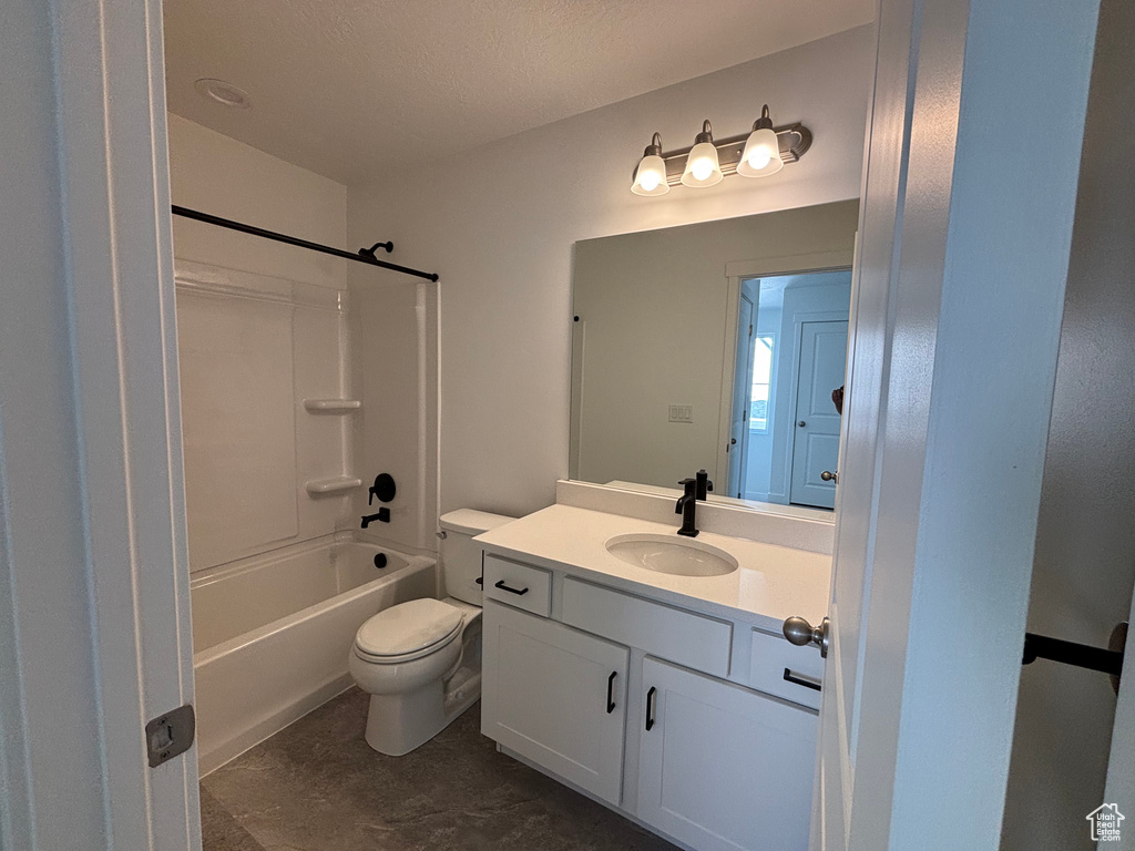 Bathroom featuring vanity, toilet, and bathtub / shower combination