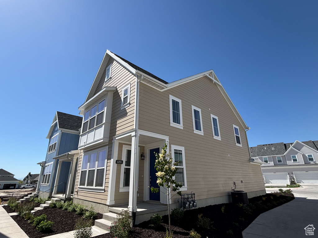 View of side of home featuring central AC unit