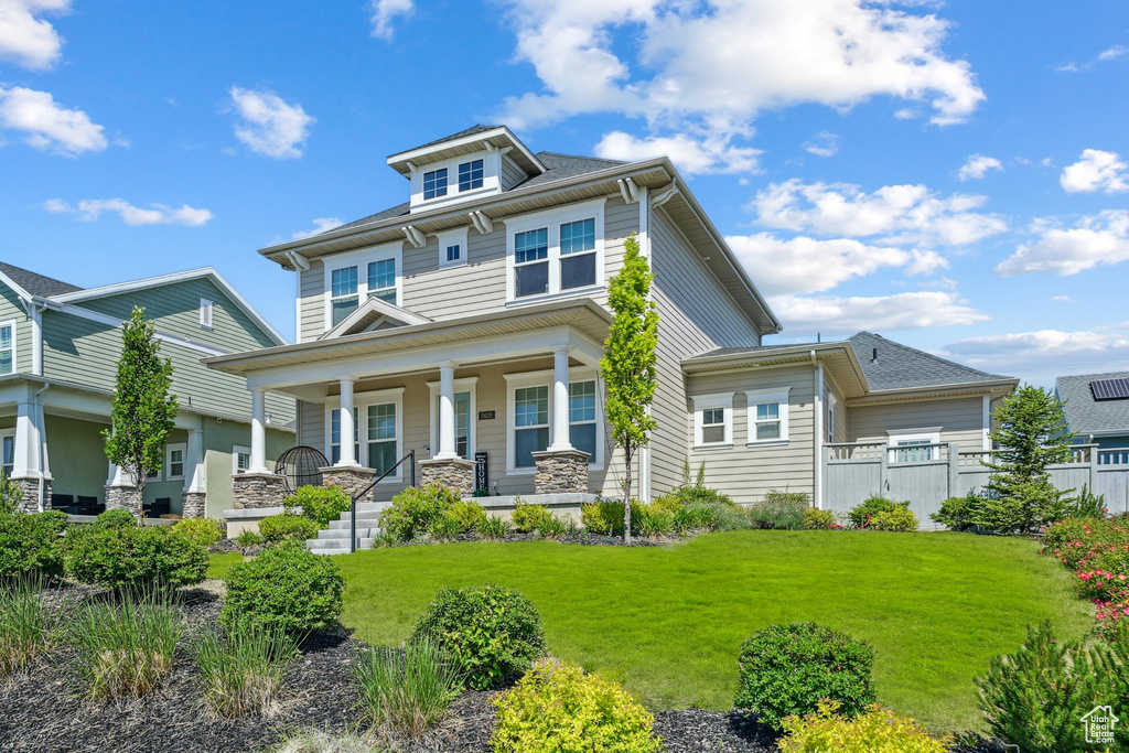 Traditional style home featuring covered porch