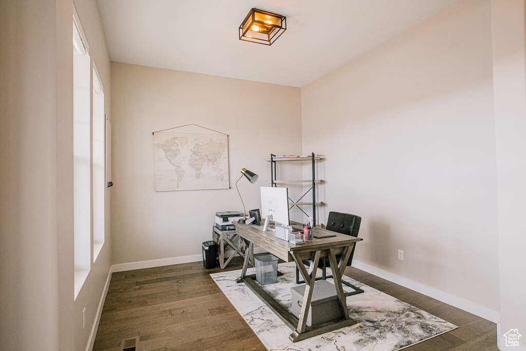 Office area featuring dark wood finished floors and baseboards