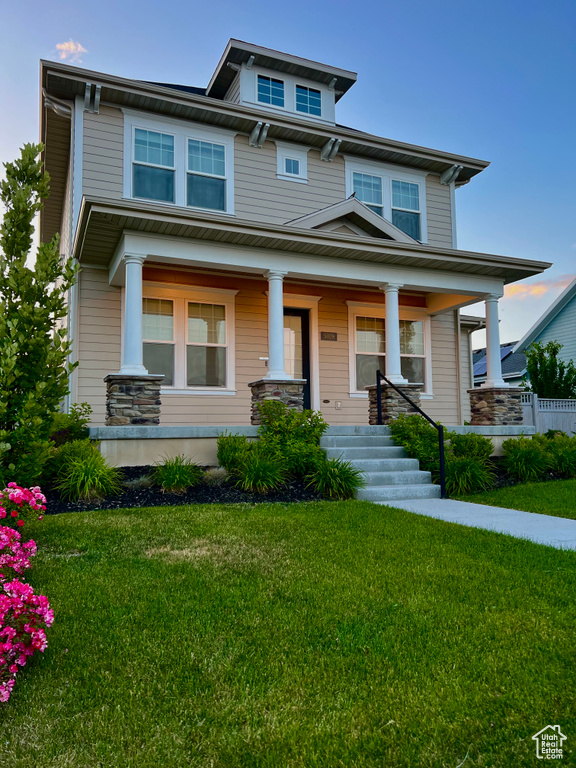 Traditional style home featuring a front yard and a porch